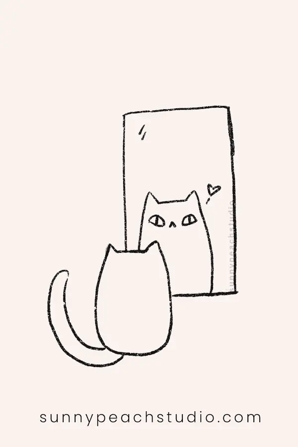 Cute cat sitting in front of a mirror and looking at its reflection