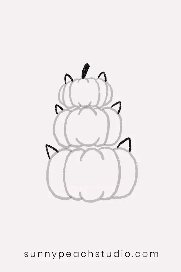 Add cat ears and a stem to the stacked pumpkins