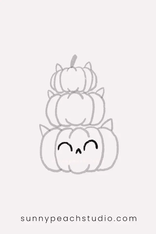 Add a cute cat face to the bottom pumpkin