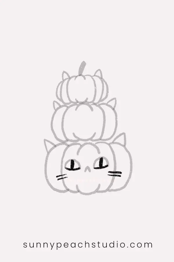Draw cat eyes and whiskers on the bottom pumpkin